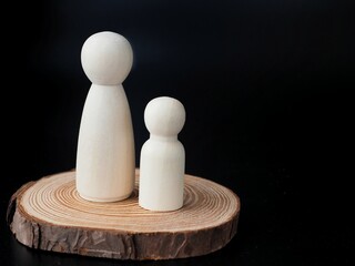 Single-mother family: A poster featuring a mother with son made with peg wooden dolls