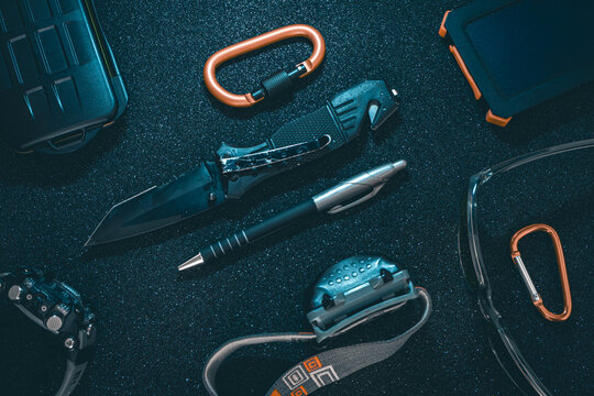 Flat lay of some Outdoor/EDC gear on a dark background.