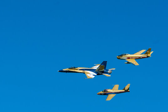 Three historic fighters commemorate the Battle of Britain.  1. A CF-18 jet painted to commemorate the 100th  anniversary of Canadian powered flight 2. F-18 Sabre Goldenhawk 3. Tudor jet Snowbird. 