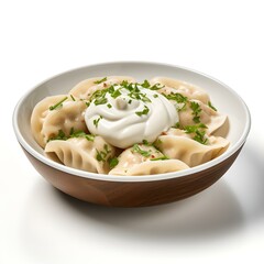 Bowl of steaming hot dumplings topped with sour cream and herbs
