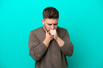Young caucasian man isolated on blue background coughing a lot