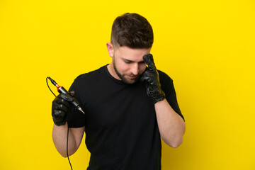 Tattoo artist man isolated on yellow background laughing