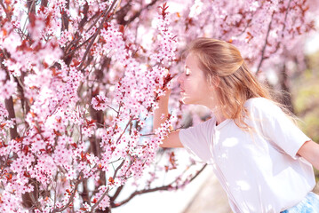 girl in a blooming sakura garden. Spring