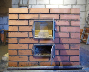 construction of brick ovens. brick stove for sauna. heating stone stove.