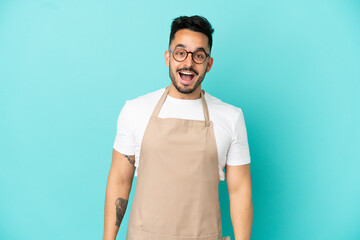 Restaurant waiter caucasian man isolated on blue background with surprise facial expression
