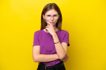 Young English woman isolated on yellow background thinking