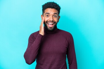 Young Brazilian man isolated on blue background with surprise and shocked facial expression