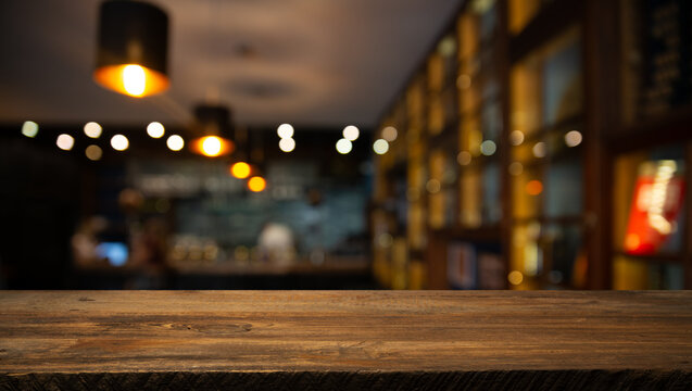 empty table to showcase your product, against the background of a blurred cafe golden bokeh. High quality photo