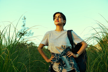 Young woman hiking in the forest at dawn 