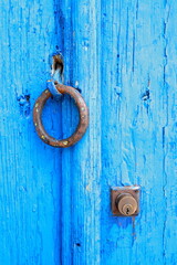 Bright blue wooden door with round handles
