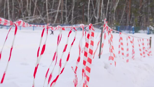 Fence ribbons sway in the wind in winter