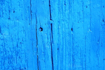 Fototapeta na wymiar Texture of blue colored wooden board with scratch. Abstract blue wall background. Vintage blue wooden surface.