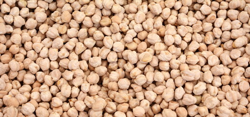Dry organic chickpeas as a background.