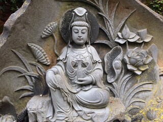 Avalokiteshvara Buddha statue carved in stone in India - obrazy, fototapety, plakaty
