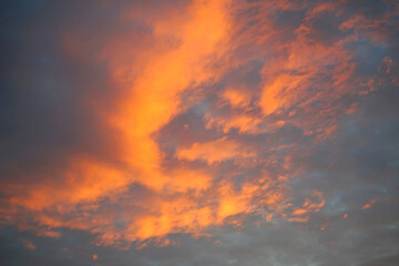 Amber Embrace: Enchanting Evening Sky with Fiery Clouds