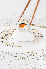 Close-up of sushi rolls made of sausage and covered with cabbage and ketchup. Homemade asian style. Sushi-food hybrids trend. Japanese food