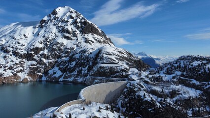 Fototapeta na wymiar Dam in the snow covered mountains