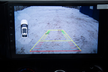 Installation of a modern multimedia system with a rear-view camera on the car. The installation center.
