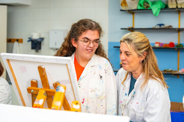 Disabled woman and teacher in a painting class