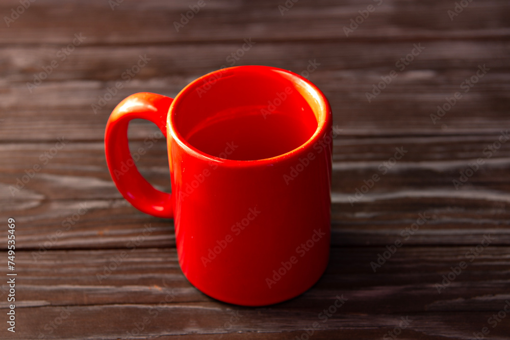 Wall mural red blank mug close-up on brown wooden background