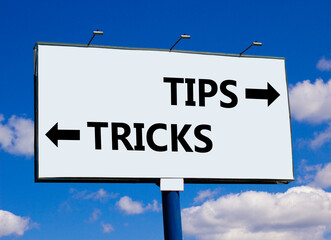 Tips and tricks symbol. Concept word Tips and tricks on beautiful billboard with two arrows....