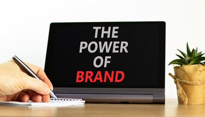 The power of brand symbol. Concept words The power of brand on beautiful black tablet. Beautiful white background. Businessman hand. Calculator. Business the power of brand concept. Copy space.