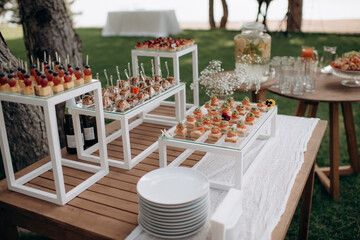 Food, a beautifully decorated catering banquet table with a variety of appetizers with cheese, ham,...