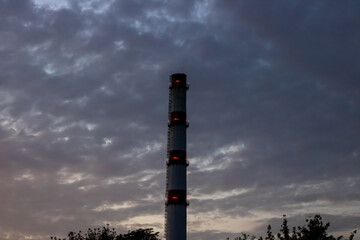 Brick chimney of factory on background of blue sky