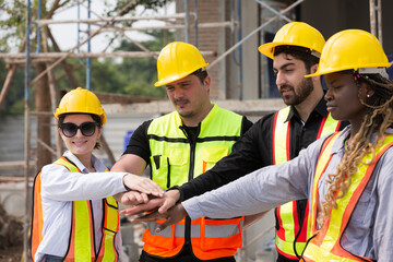 Group of male and female engineer construction working and join hands together at construction site. Foreman construction working at construction site - obrazy, fototapety, plakaty