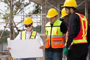 Group of male and female engineer construction working together at construction site. Foreman...