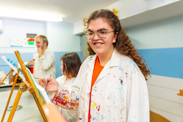 Disabled woman smiling during painting class indoors
