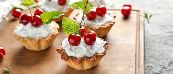 Tasty tartlet with fresh cherries on table, closeup