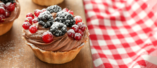 Tasty tartlet with fresh berries on table, closeup