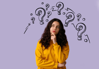 Thoughtful young woman on lilac background