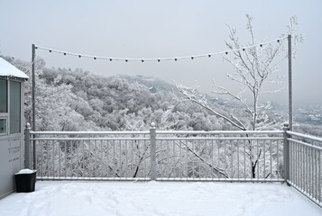 Mountain viewpoint on a winter day with hills in the background