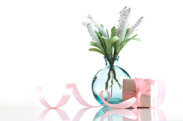 Flowers in vase and gift box on white background. Mother's day.Women's day.