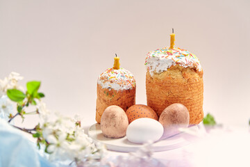 Fototapeta na wymiar Two paski with candles and eggs on white background