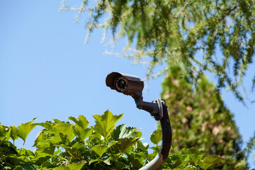 Video surveillance camera against the blue sky....