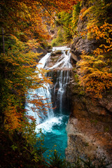 Autumn wonders of Ordesa and Monte Perdido: the Arazas River meanders among trees in flames, an...
