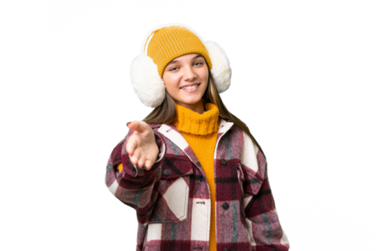 Teenager caucasian girl wearing winter muffs over isolated background shaking hands for closing a good deal