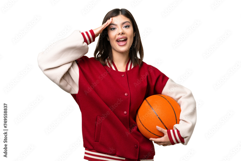 Wall mural Young Russian woman playing basketball over isolated chroma key background with surprise expression