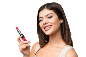 Young Russian woman with rainproof coat and umbrella over isolated chroma key background holding red lipstick