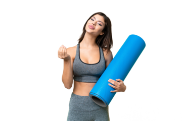 Young sport woman going to yoga classes while holding a mat over isolated chroma key background making money gesture