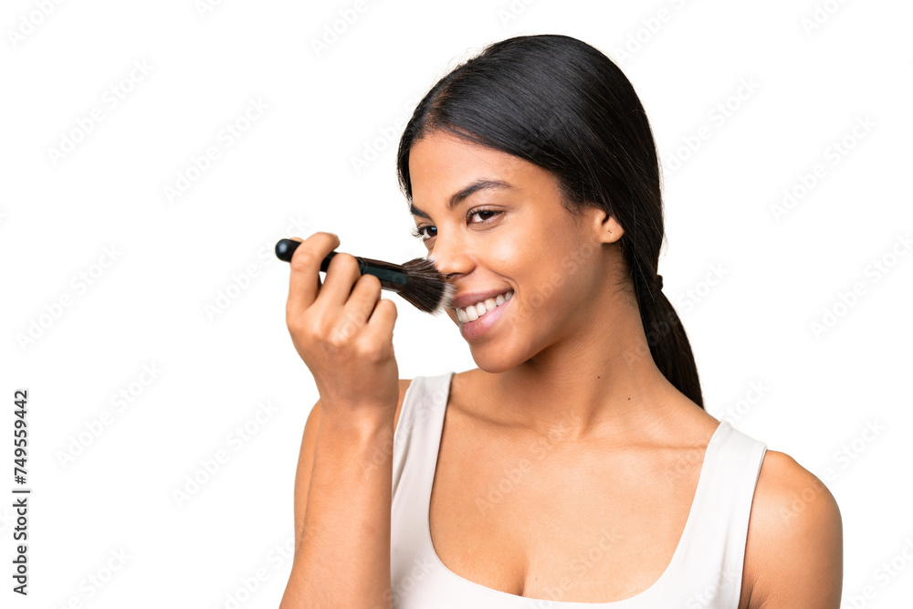 Wall mural Young woman over over isolated chroma key background holding makeup brush and whit happy expression