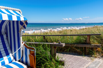 Blue white beach chair with the Beach Idyl of Scharbeutz in background, Baltic sea, Germany