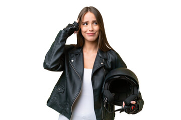 Young pretty caucasian woman with a motorcycle helmet over isolated background having doubts and...