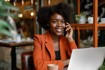 A business woman is talking on the phone with a laptop in a cafe.