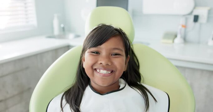 Dentist, smile and face of child for teeth, orthodontics and wellness in medical health. Dental care, happy and portrait of female patient for healthcare, oral hygiene and confidence at clinic.