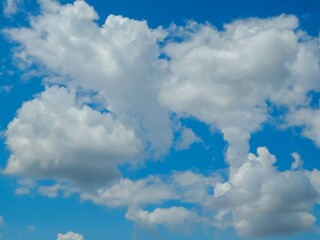 Picturesque Blue Sky with Fluffy White Clouds in a Serene Background