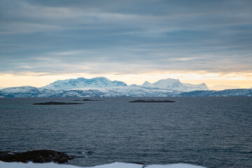 Magnificent views of distant snow-capped mountains on Vestfjorden on the Lofoten Islands in Norway